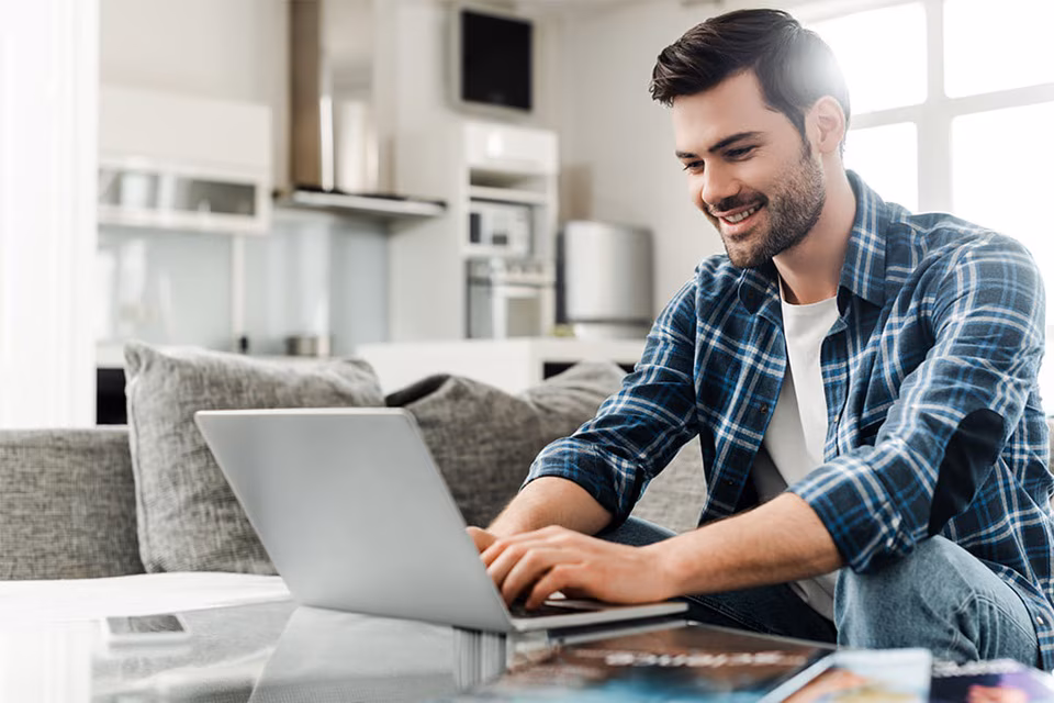An Auto Glass University student using a laptop while learning at home